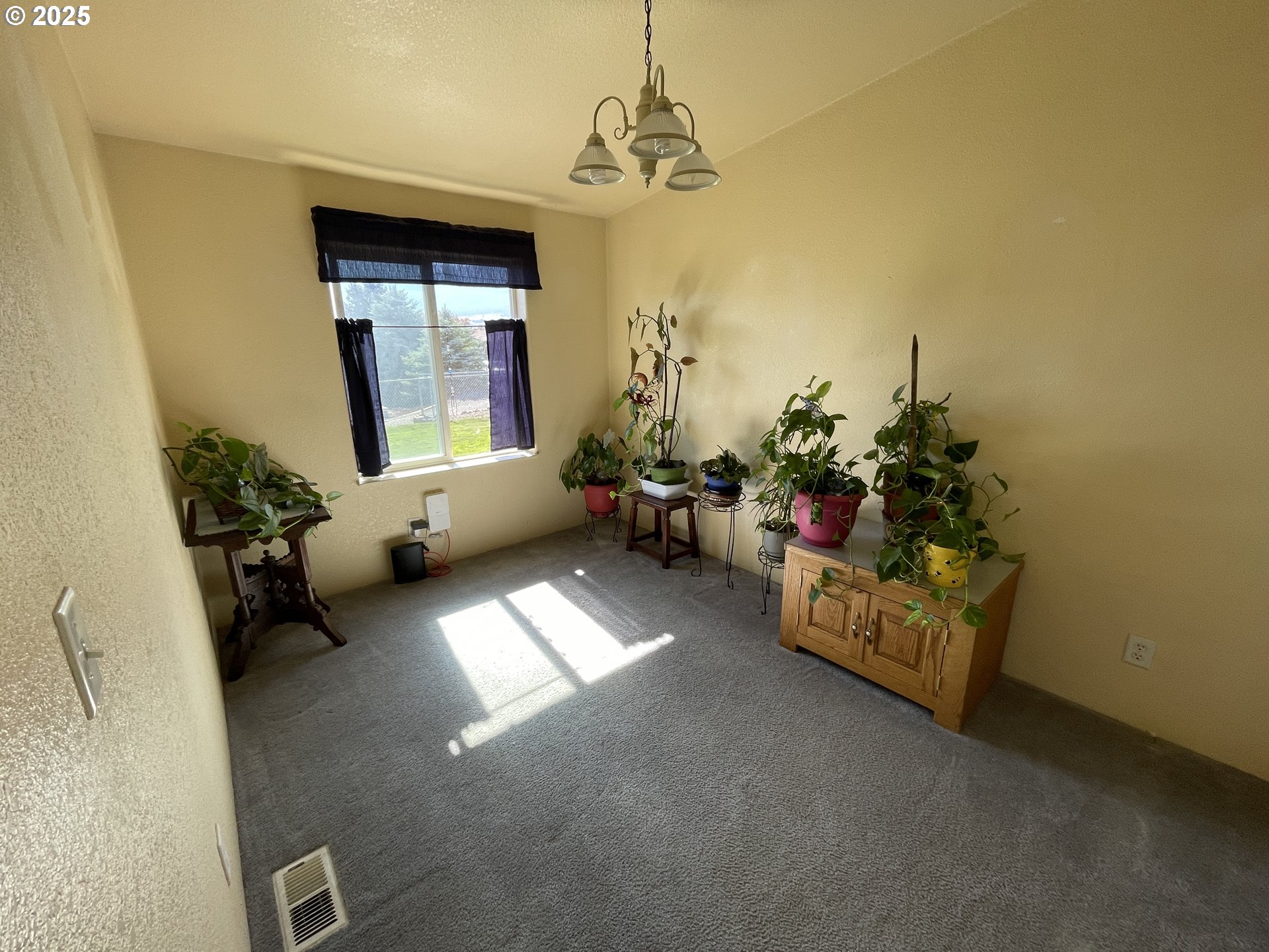 203 Court Street Enterprise, OR 97828 - Photo 23 of 23 a living room with furniture and a chandelier