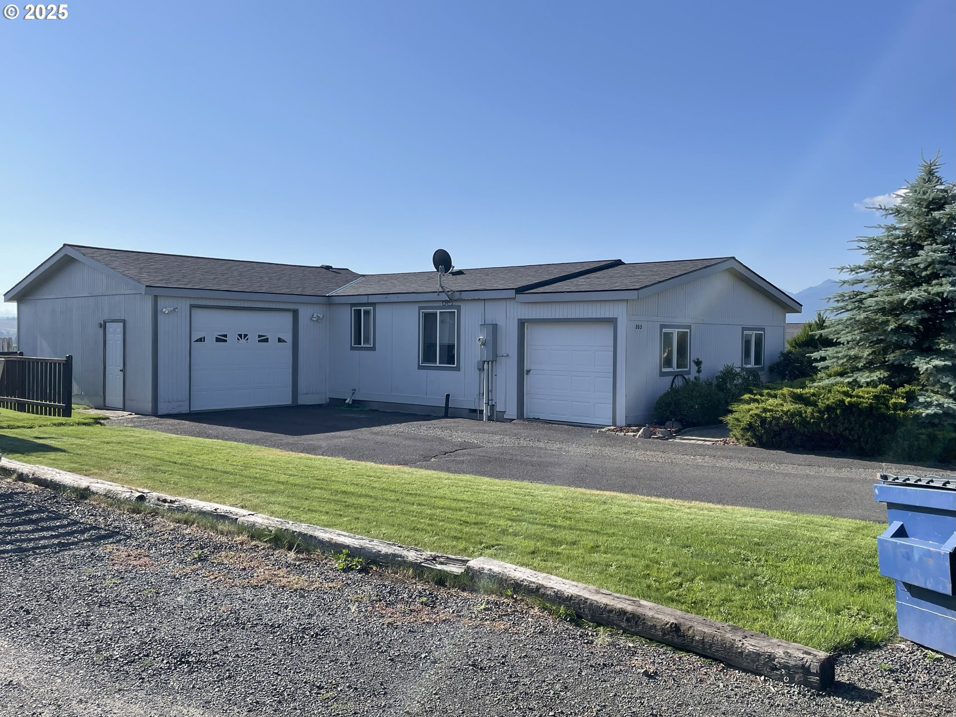 203 Court Street Enterprise, OR 97828 - Photo 3 of 23 a view of a house with a yard and a large tree