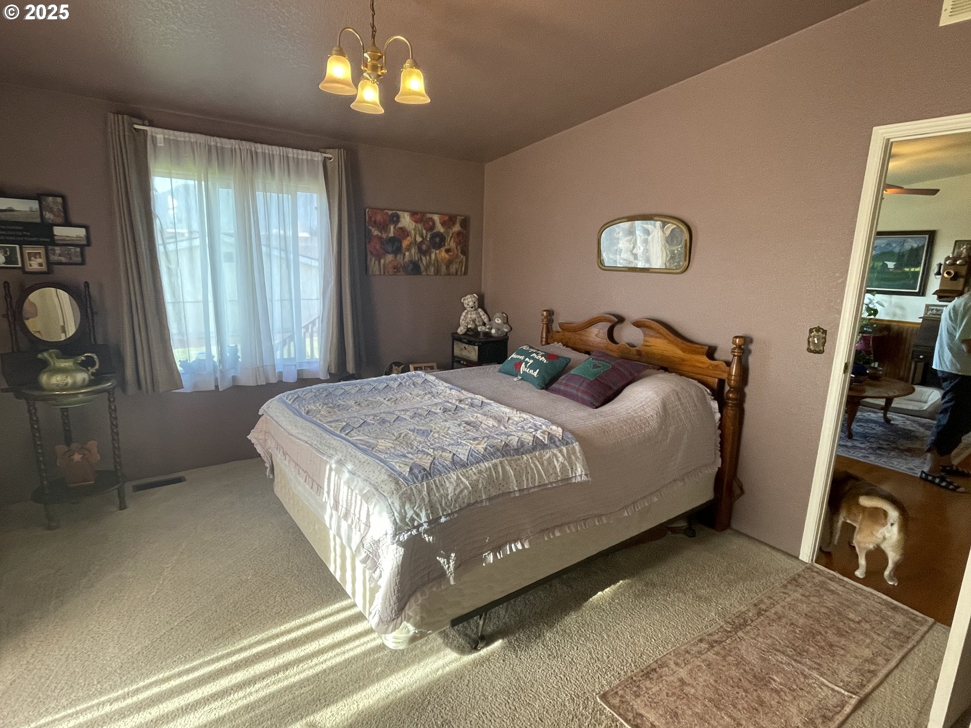203 Court Street Enterprise, OR 97828 - Photo 10 of 23 a bedroom with a bed and a chandelier