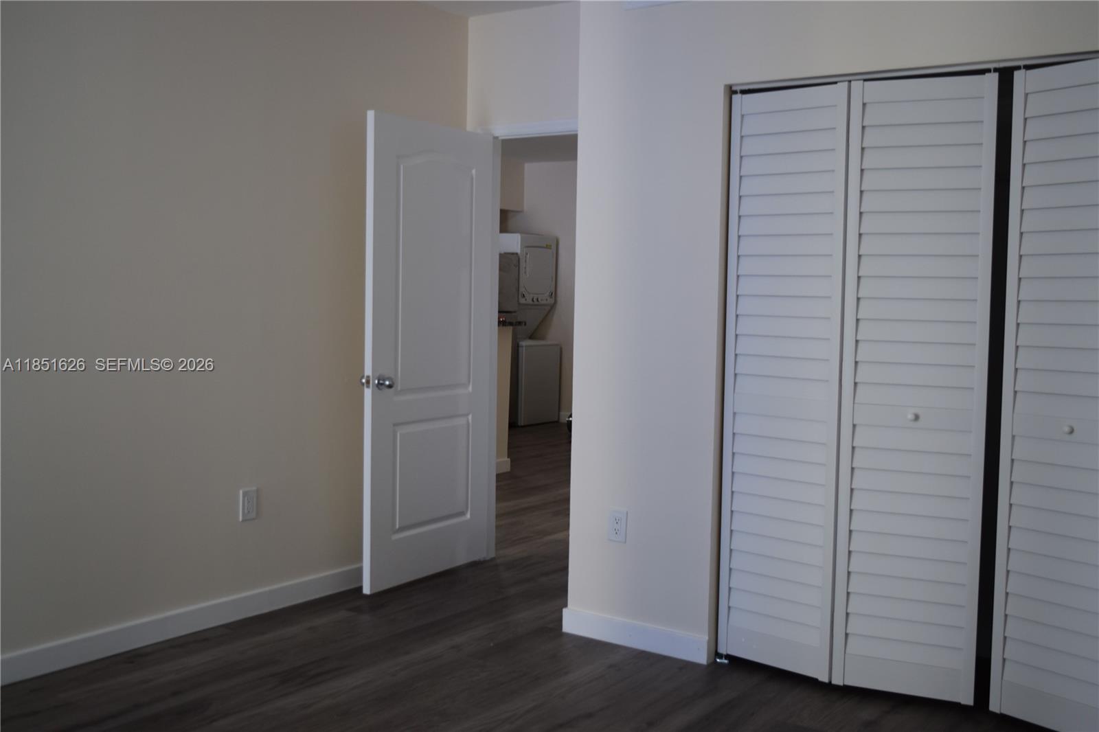 5091 Northwest 7th Street, Unit 711 Miami, FL 33126 - Photo 16 of 72 an empty room with wooden floor