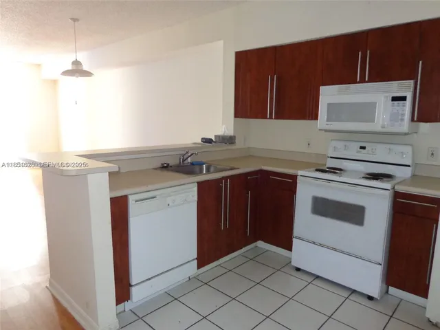 a kitchen with a stove and a microwave