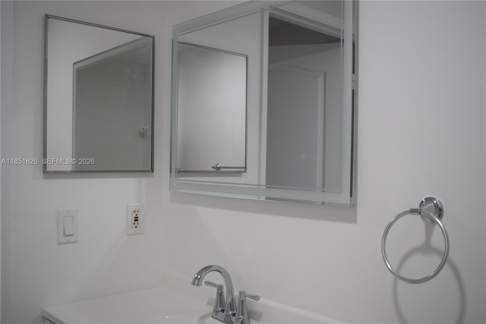 5091 Northwest 7th Street, Unit 711 Miami, FL 33126 - Photo 18 of 72 a bathroom with a sink and mirror