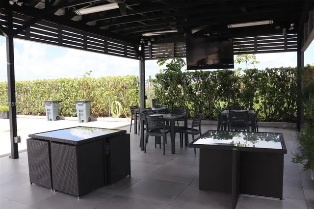 a view living room with patio furniture and a potted plant
