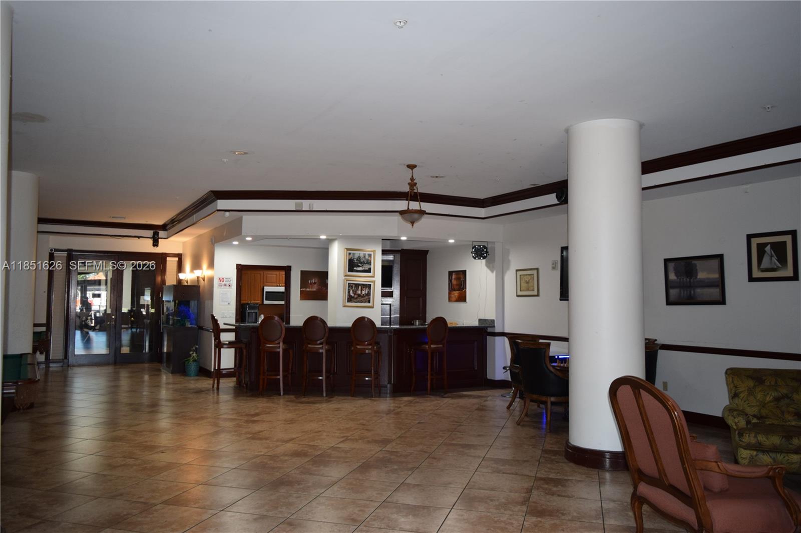 5091 Northwest 7th Street, Unit 711 Miami, FL 33126 - Photo 45 of 72 a view of a big room with wooden floor windows and chandelier