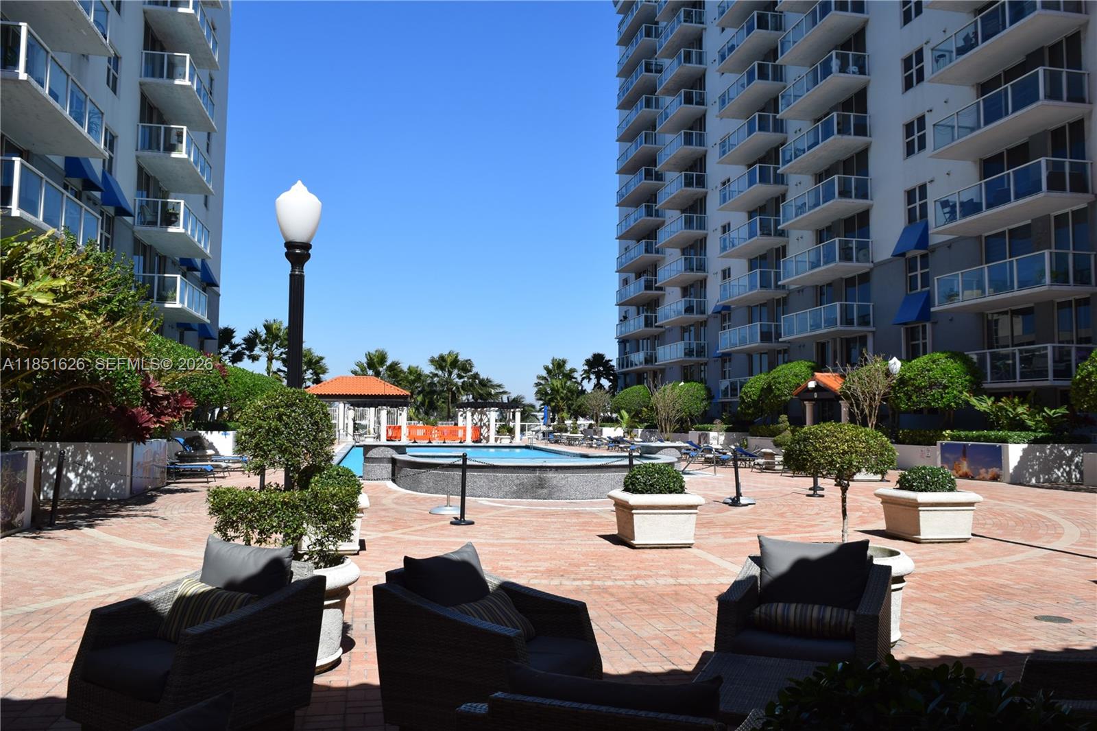 5091 Northwest 7th Street, Unit 711 Miami, FL 33126 - Photo 48 of 72 a view of a patio with couches and potted plants