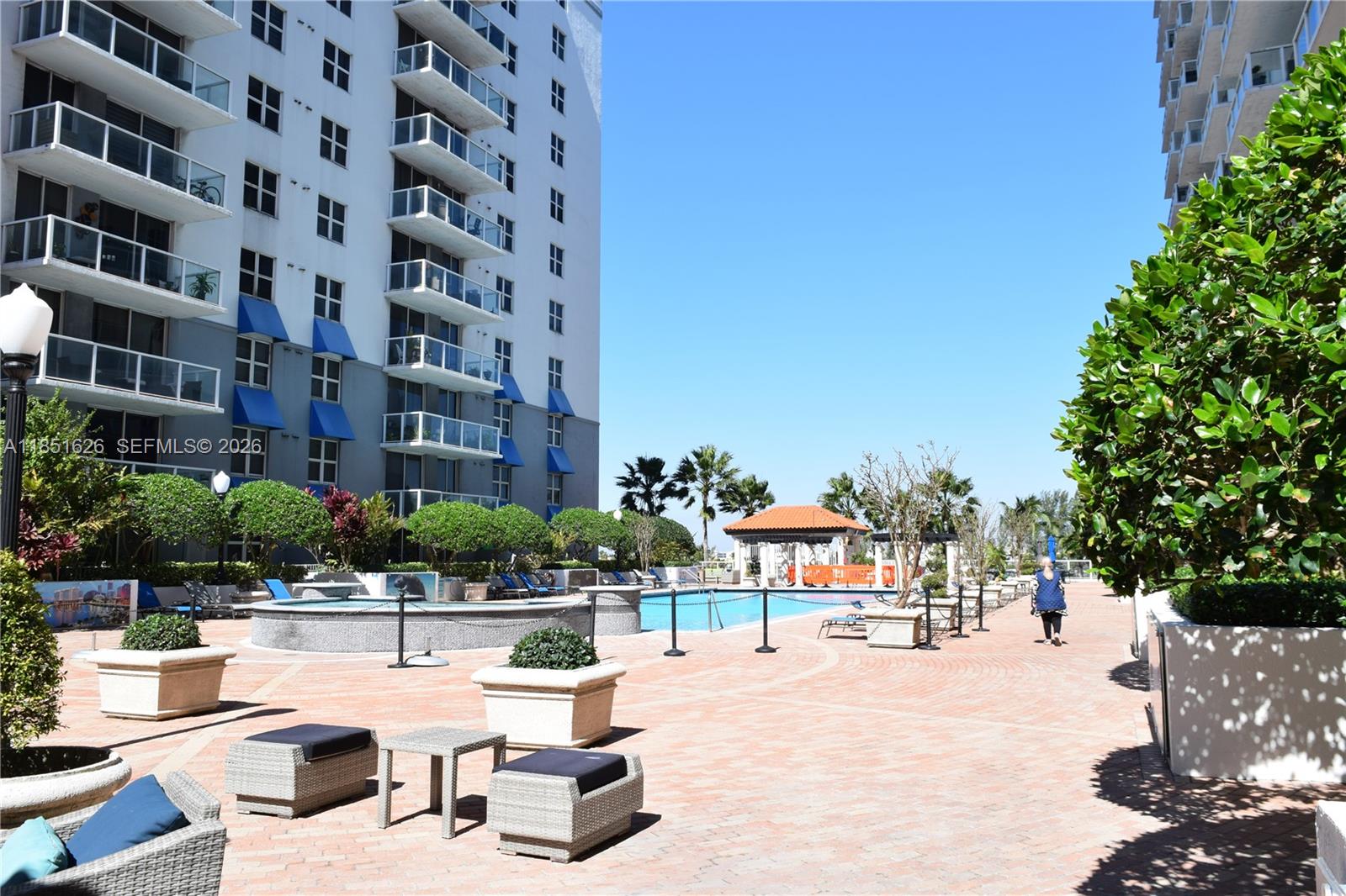 5091 Northwest 7th Street, Unit 711 Miami, FL 33126 - Photo 53 of 72 a view of a building with garden and sitting area