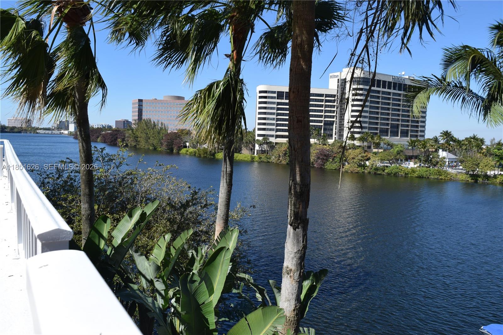 5091 Northwest 7th Street, Unit 711 Miami, FL 33126 - Photo 58 of 72 a view of a backyard of a house with a lake from a outdoor space