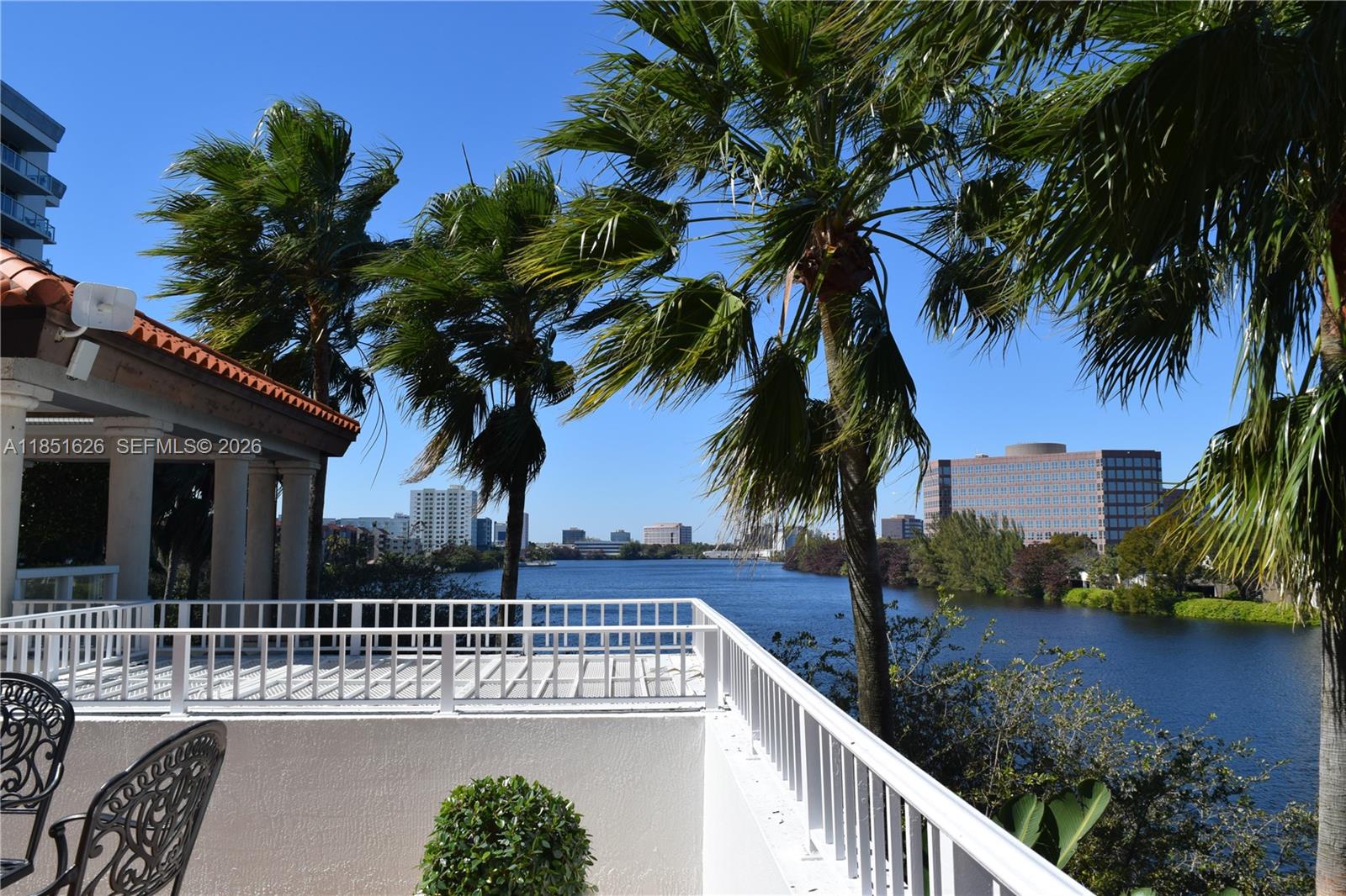 5091 Northwest 7th Street, Unit 711 Miami, FL 33126 - Photo 59 of 72 a view of swimming pool with a table and chairs