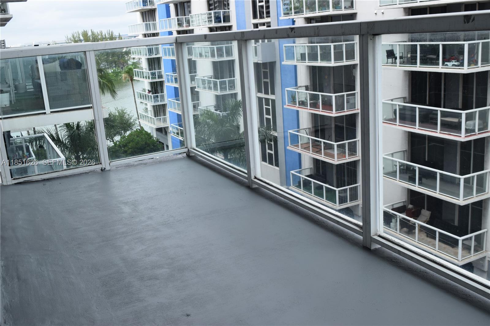 5091 Northwest 7th Street, Unit 711 Miami, FL 33126 - Photo 68 of 72 a view of a balcony with a large window and stairs