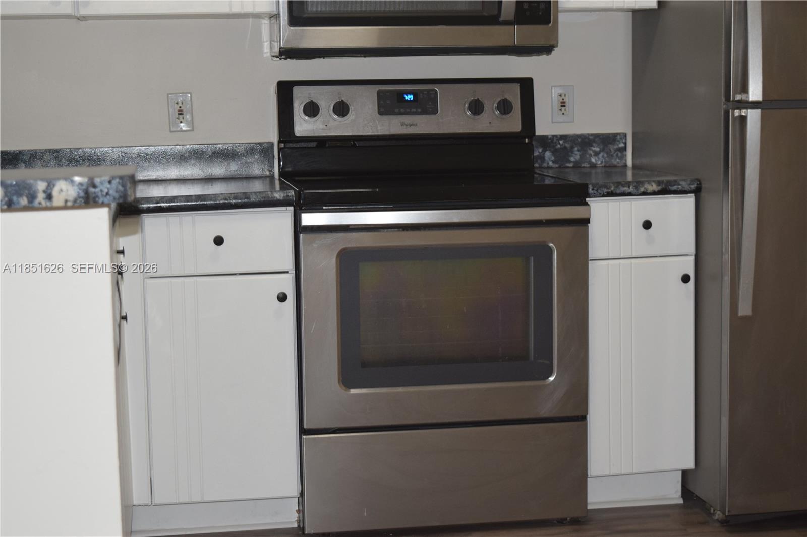 5091 Northwest 7th Street, Unit 711 Miami, FL 33126 - Photo 7 of 72 a stove top oven sitting inside of a kitchen