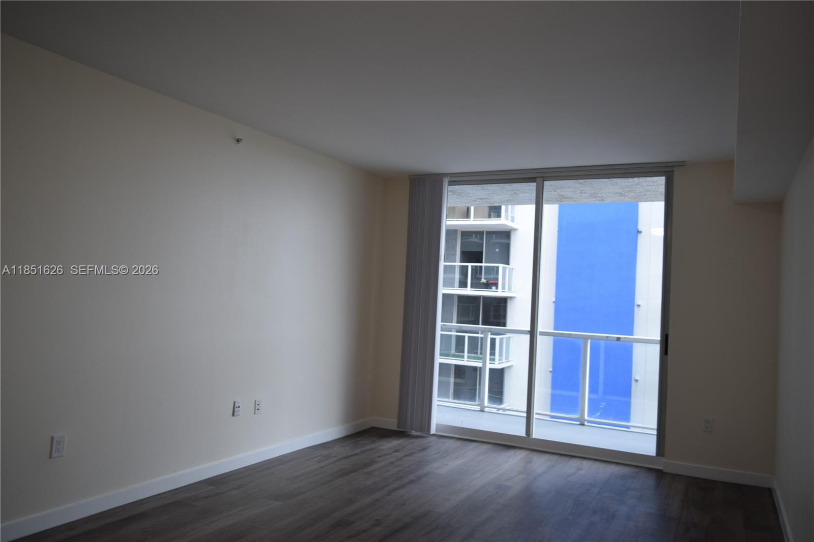 5091 Northwest 7th Street, Unit 711 Miami, FL 33126 - Photo 72 of 72 an empty room with wooden floor and windows