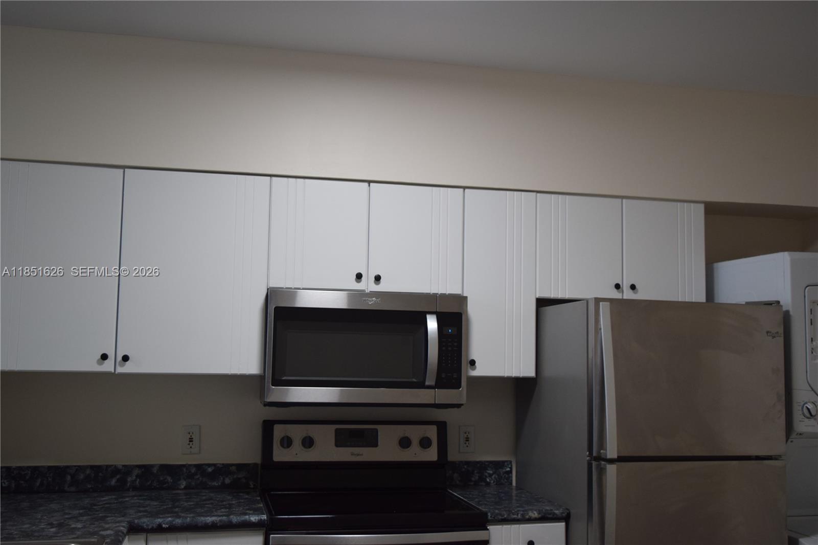 5091 Northwest 7th Street, Unit 711 Miami, FL 33126 - Photo 10 of 72 a kitchen with stainless steel appliances a refrigerator and a microwave