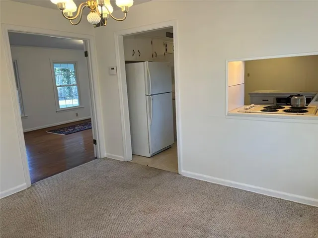 a view of a kitchen with a refrigerator and cabinet