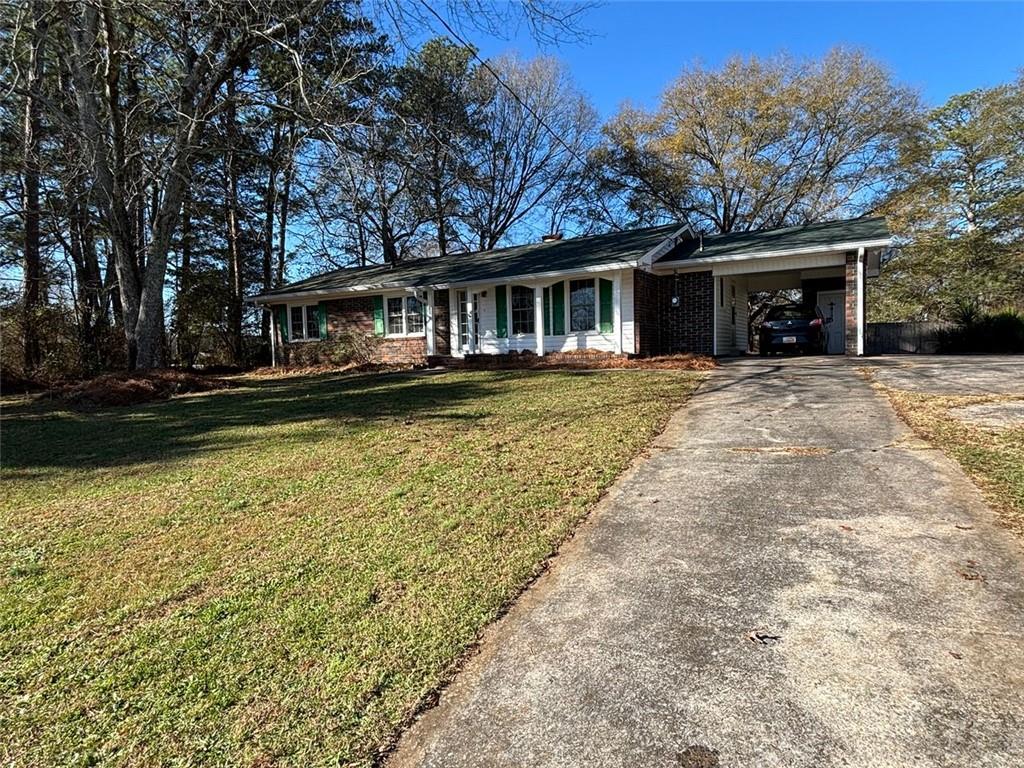 814 Shannon Circle Northeast Rome, GA 30161 - Photo 2 of 47 a front view of a house with a garden and trees