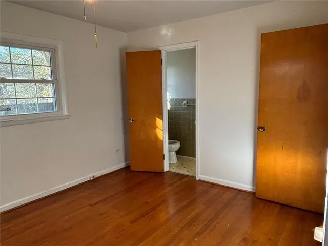 a bathroom with a toilet a sink and a mirror
