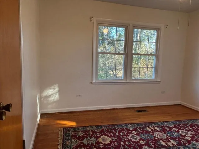 a view of a room with wooden floor