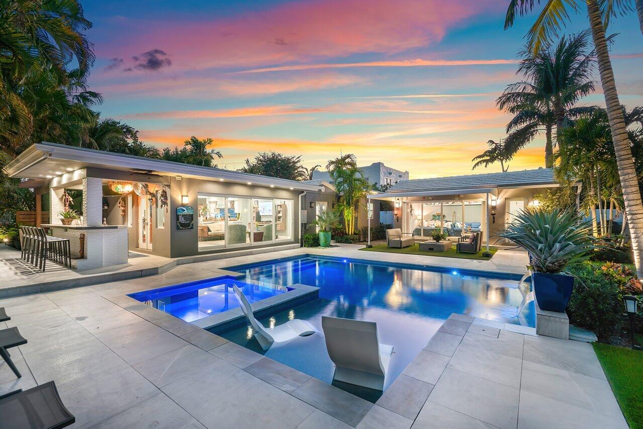 a view of swimming pool with outdoor seating and a potted plants