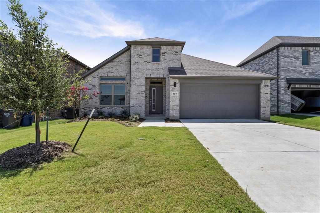 507 Avocet Road Princeton, TX 75407 - Photo 1 of 31 Brick veneer exterior with a prominent entryway, attached garage, concrete driveway, and a landscaped front yard