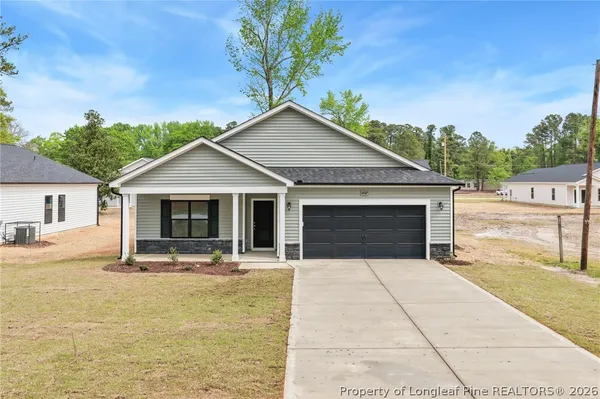 a front view of a house with yard and green space
