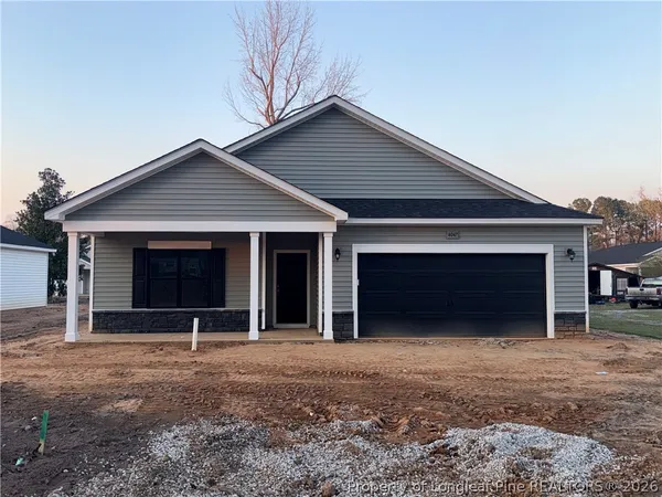 a front view of a house with a yard and garage