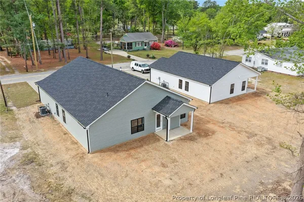 an aerial view of residential houses with outdoor space
