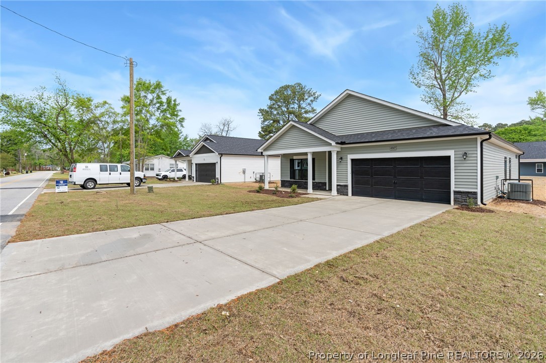 4047 Church Street Wade, NC 28395 - Photo 27 of 30 a front view of a house with a yard and garage