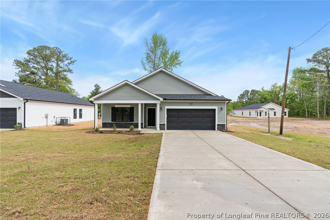 4047 Church Street Wade, NC 28395 - Photo 29 of 30 a front view of a house with a garden and yard