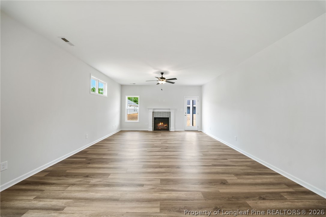 4047 Church Street Wade, NC 28395 - Photo 4 of 30 a view of empty room with wooden floor and fireplace