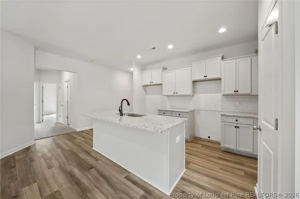 a kitchen with a sink stove and cabinets