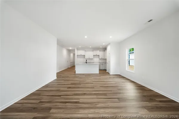 a view of kitchen and hall with wooden floor