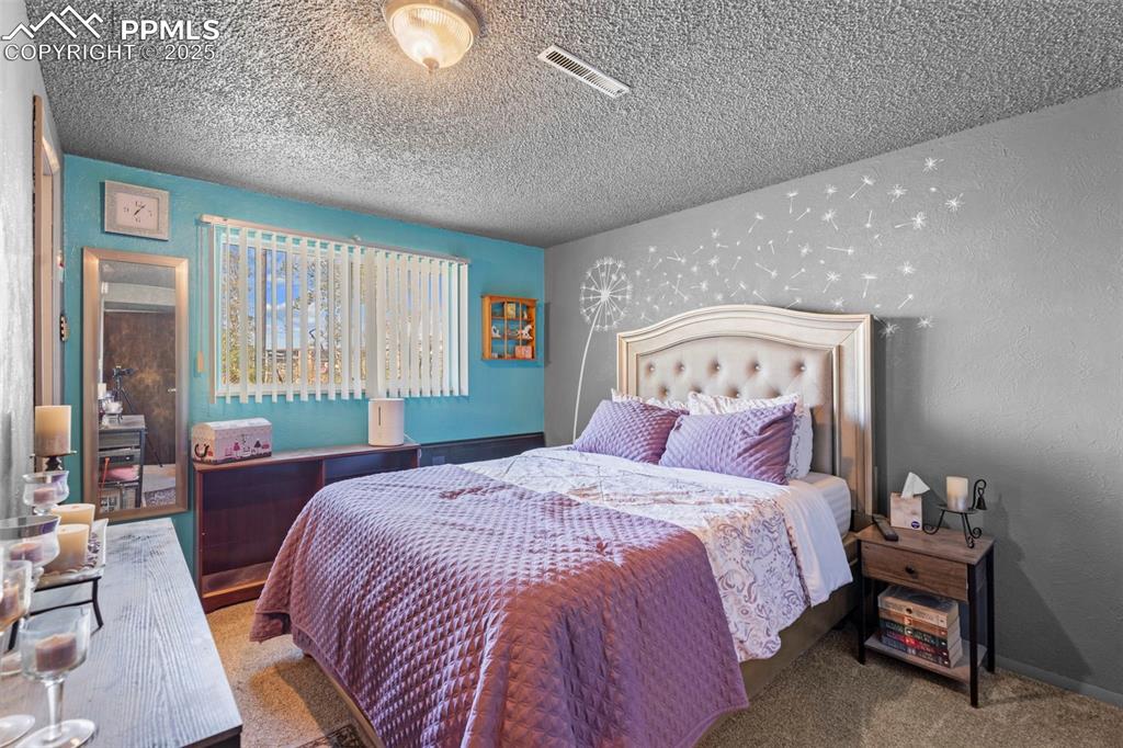 47801 Pheasant Crest Road Avondale, CO 81022 - Photo 11 of 22 a bedroom with a large bed and a lamp
