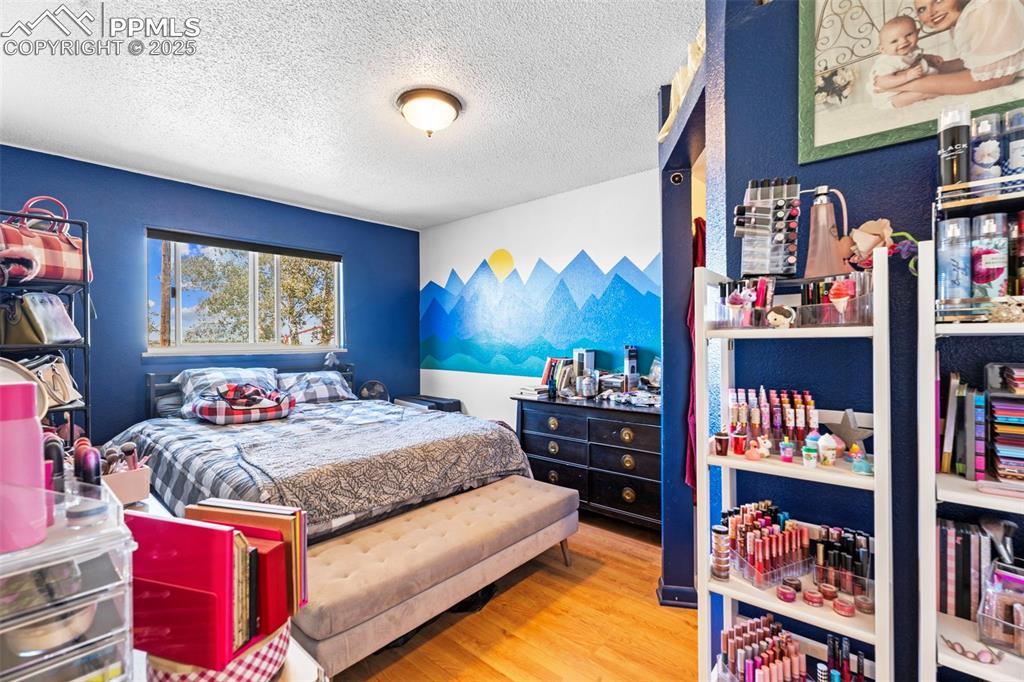 47801 Pheasant Crest Road Avondale, CO 81022 - Photo 12 of 22 a bedroom with furniture and a book shelf