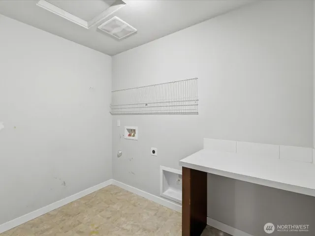 a bedroom with bed and a potted plant