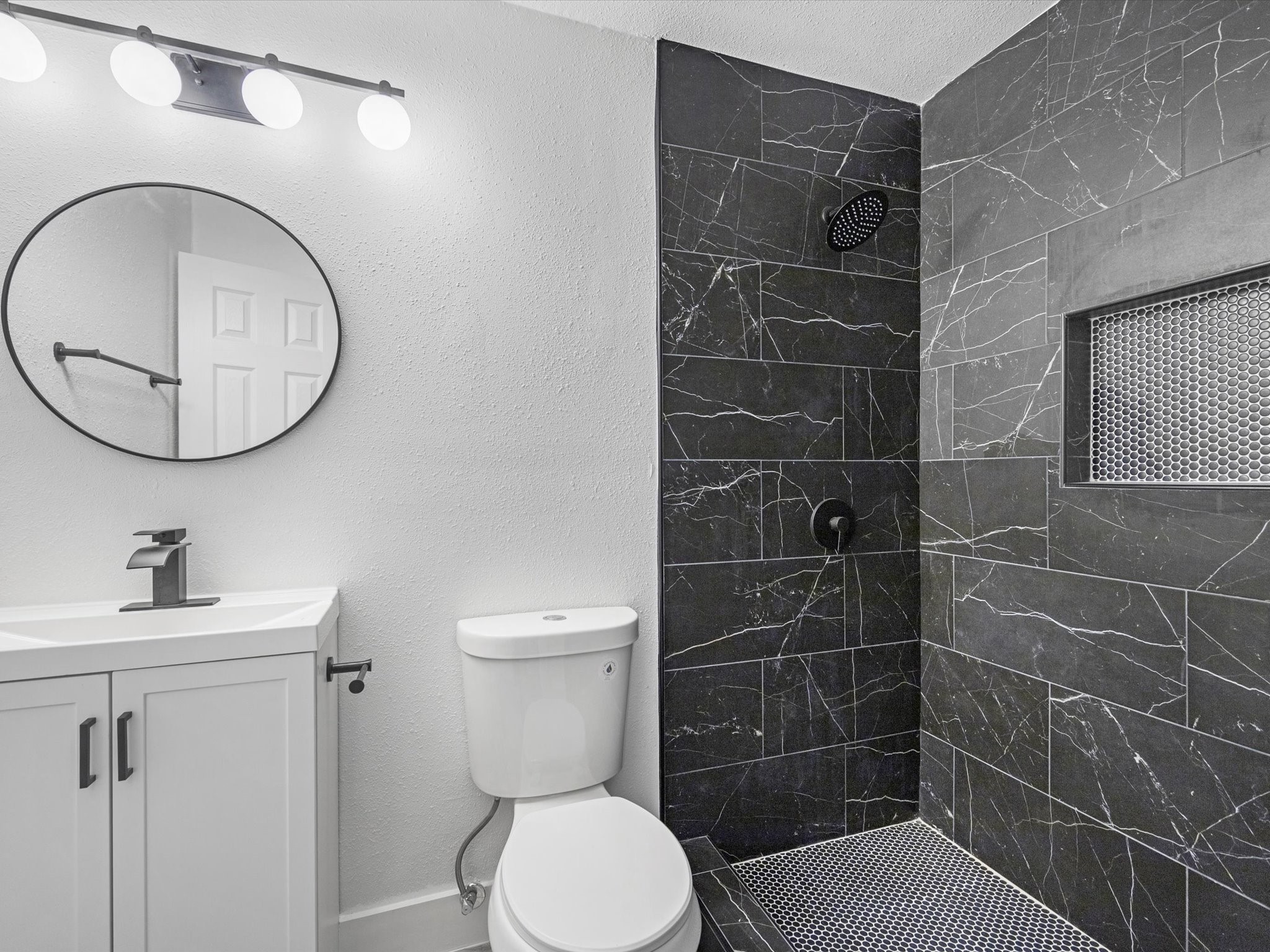 1217 Randall Street Pasadena, TX 77506 - Photo 13 of 16 a bathroom with a toilet a sink and mirror