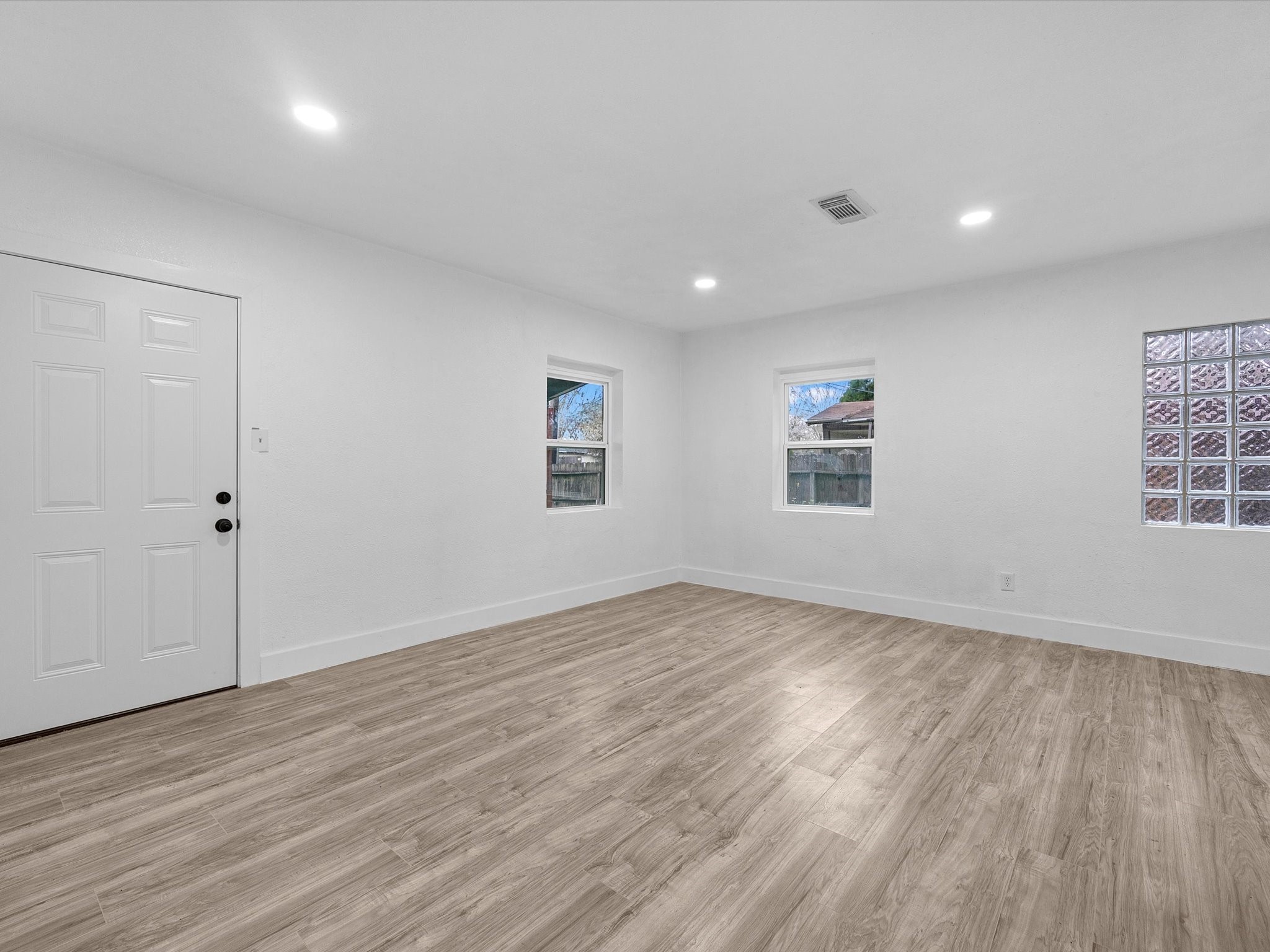 1217 Randall Street Pasadena, TX 77506 - Photo 4 of 16 an empty room with wooden floor and windows