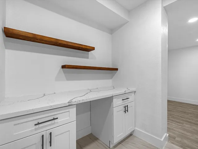 a kitchen with white cabinets and white appliances