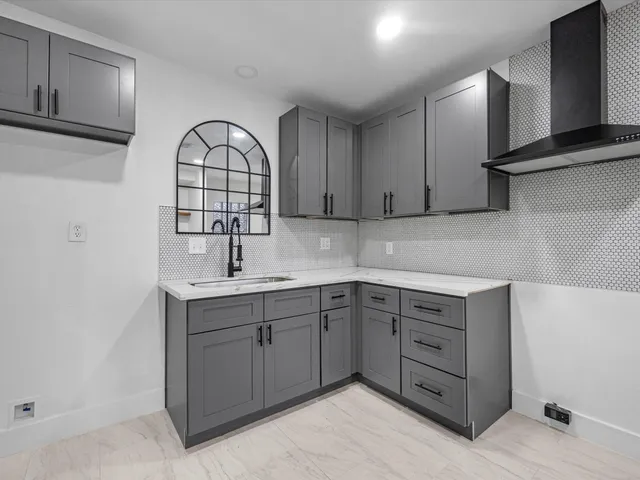 a kitchen with cabinets and window
