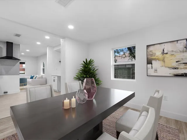 a view of a dining room with furniture and wooden floor