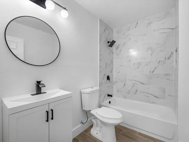 a bathroom with a sink a toilet and a mirror