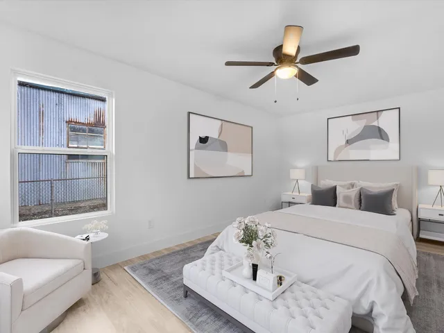 a bedroom with a bed and a painting on the wall