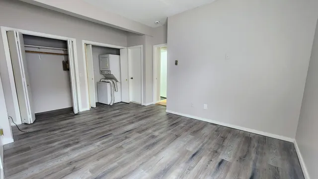 a view of an empty room with wooden floor