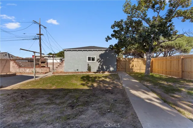 a view of a backyard with a tree