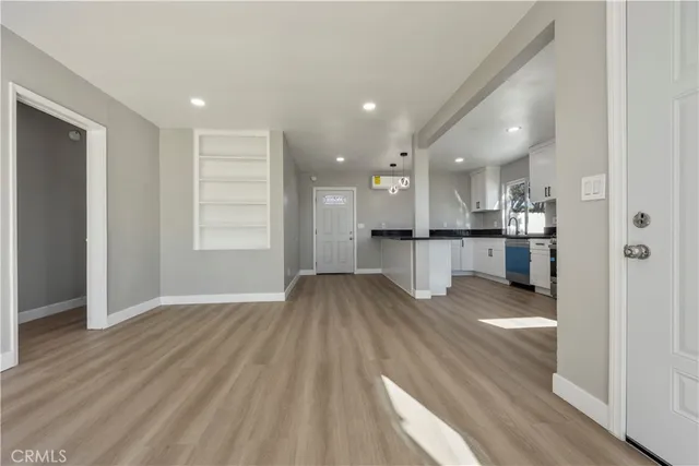 a view of kitchen view wooden floor and kitchen view