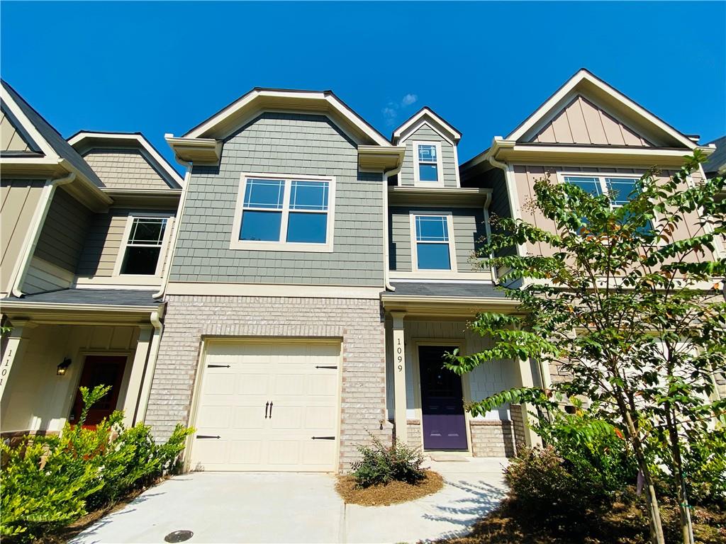 front view of a brick house with a small yard
