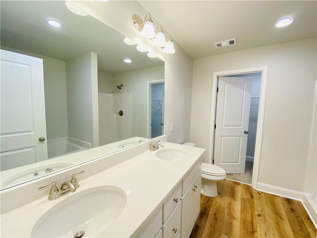 1099 North Village Drive Decatur, GA 30032 - Photo 12 of 23 a spacious bathroom with a sink a large mirror and shower