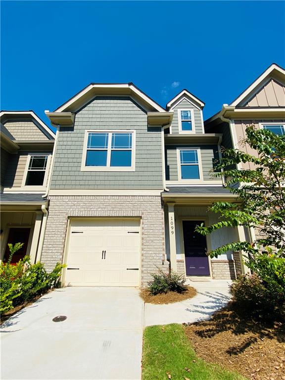 1099 North Village Drive Decatur, GA 30032 - Photo 2 of 23 a front view of a house with a yard and garage