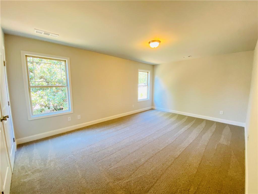 1099 North Village Drive Decatur, GA 30032 - Photo 10 of 23 an empty room with wooden floor and windows