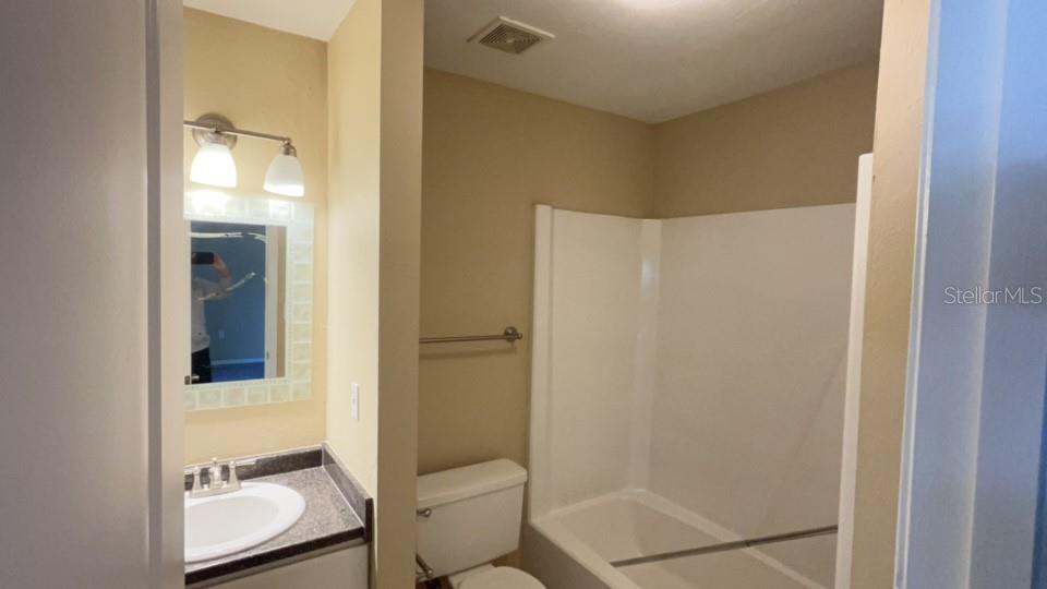 507 Northwest 39th Road, Unit 310 Gainesville, FL 32607 - Photo 12 of 18 a bathroom with a sink and mirror
