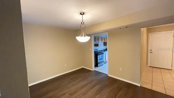 a view of a room with wooden floor and white walls