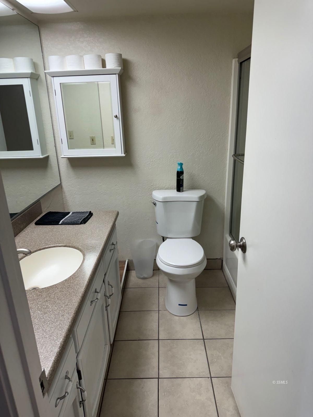 1505 South Farragut Street Ridgecrest, CA 93555 - Photo 7 of 12 a white toilet sitting next to a bathroom sink